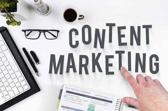 Pointing at the “Content Marketing” writing on a table