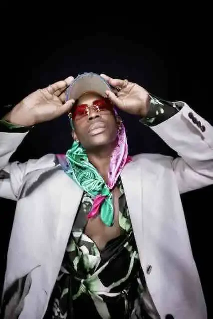 Stylish man wearing colorful accessories and trendy outfit for LGBTQ+ pride.
