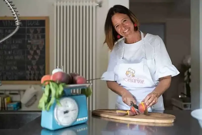 Delicious woman chopping vegetables in a cozy kitchen for a divine magazine feature.
