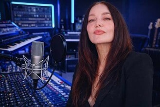 Betty Moon recording in a professional music studio with mixing consoles and audio equipment.