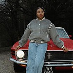 Brenique Adams standing in front of a vintage red car, promoting her Oasis EP and new single "Light.