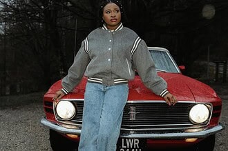 Brenique Adams standing in front of a vintage red car, promoting her Oasis EP and new single "Light.
