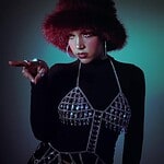 JULITH wearing a furry hat and stylish jewelry, promoting her debut EP.