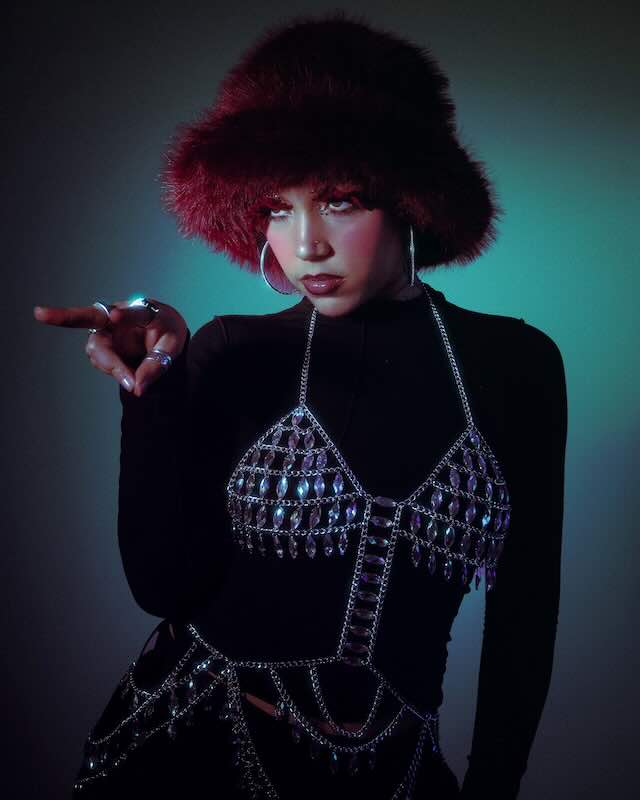JULITH wearing a furry hat and stylish jewelry, promoting her debut EP.