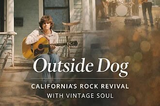Young man playing acoustic guitar on porch during outdoor music event in California.