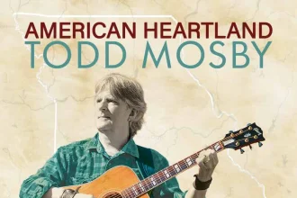 Todd Mosby playing guitar outdoors in a natural setting, promoting slow living and American heartlan.