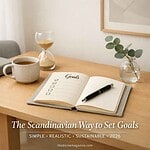 Scandinavian-style desk with goals planner, coffee, and greenery for 2026 goal setting.